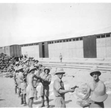Boys stacking wood - Army dump
