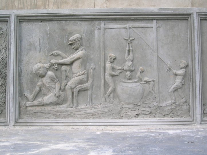 Image carved into the memorial showing some of the torture methods