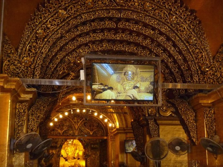 There are TV screens around the pagoda so you can see the gold leaf being applied.  Also its men only so close to the Buddha as in most Myanmar pagodas.