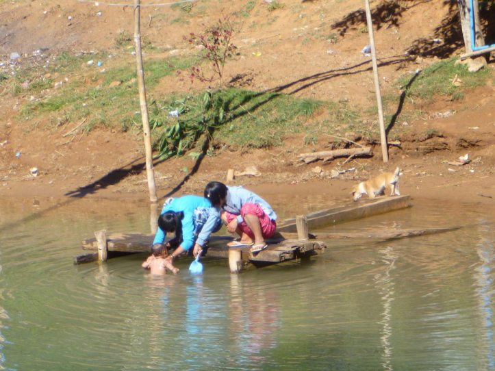 Bath time for baby in the river
